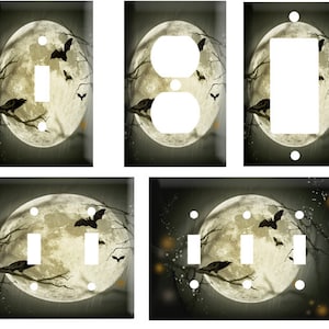 May include: A set of four light switch and outlet covers featuring a spooky Halloween scene with a full moon, bats, and ravens. The covers are designed to fit standard US electrical outlets and switches.