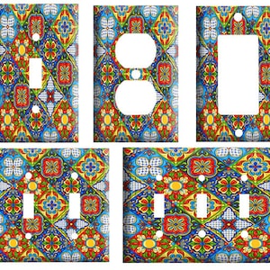 May include: Set of four decorative light switch and outlet covers featuring a colorful, geometric tile pattern in shades of blue, red, yellow, and green.