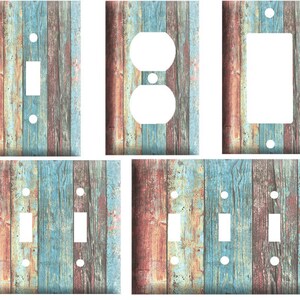 May include: Set of six light switch and outlet covers featuring a rustic wood plank design with blue, brown, and red tones.
