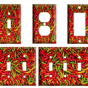 May include: A set of light switch and outlet covers featuring a close-up image of red and green chili peppers.