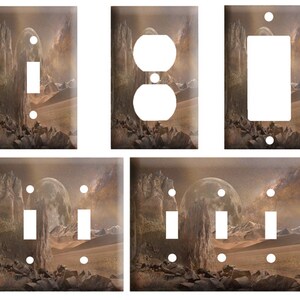 May include: Set of six light switch and outlet covers featuring a fantasy landscape with a full moon, rocky mountains, and a starry sky. The covers are available in single, double, and triple switch configurations.
