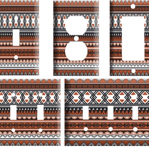 May include: Set of four decorative light switch and outlet covers featuring a geometric pattern in shades of brown, black, white, and gray. The pattern is reminiscent of Native American or tribal art.