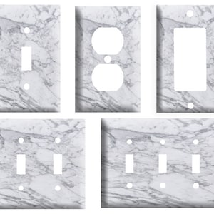 May include: Set of five white marble switch plate covers with different configurations: single switch, double switch, triple switch, and outlet. The plates have a realistic marble pattern.