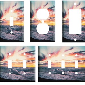 May include: A set of six light switch and outlet covers featuring a vibrant sunset over a sea of clouds. The covers are available in single, double, and triple switch and outlet configurations.