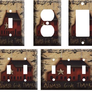 May include: Set of five light switch and outlet covers featuring a rustic farmhouse design with a red barn, a star, and the text "Always Give Thanks".