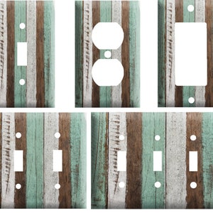 May include: Set of six light switch and outlet covers featuring a weathered wood plank design with brown, white, and teal blue stripes.