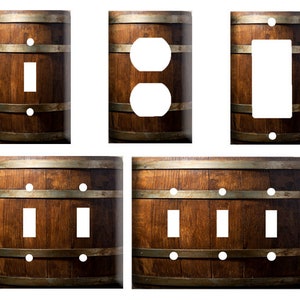May include: Set of five light switch and outlet covers featuring a rustic wood grain design with metal accents. The covers are available in single, double, and triple switch configurations.