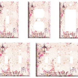 May include: Set of five light switch and outlet covers featuring a Parisian-themed design with pink roses, a street lamp, and the Eiffel Tower. The background is a light beige with a white star pattern.