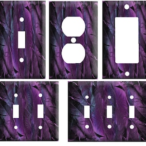May include: Set of six purple and black feather patterned light switch and outlet covers. The covers are designed to fit standard US electrical outlets and light switches.