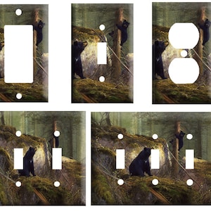 May include: Set of six light switch and outlet covers featuring a black bear and cub in a forest setting. The covers are made of durable plastic and are easy to install.