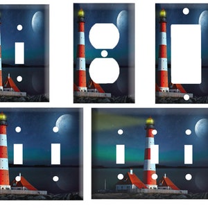 May include: Set of five light switch and outlet covers featuring a lighthouse with red and white stripes against a blue night sky with stars and a crescent moon.