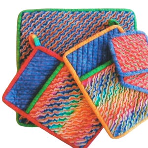 May include: A white ceramic mug with a black handle and the text "But First, Coffee" in a bold, black font. The mug is filled with a dark liquid, likely coffee, and sits on a light-colored surface.