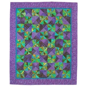 May include: A purple and green quilt with a geometric pattern. The quilt is made up of squares and triangles, and the colors are vibrant and bold.