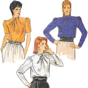 May include: Illustration of three blouses in different colors: yellow, blue with pink floral pattern, and white. Each blouse has a high neckline, puffed sleeves, and is paired with a skirt. The blouses are tucked in and belted at the waist.