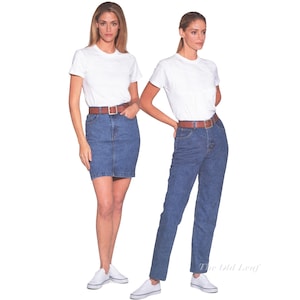 May include: Two outfits consisting of a plain white short-sleeved t-shirt, a brown leather belt with a silver buckle, and white sneakers. One outfit includes a blue denim skirt, while the other features blue denim jeans. The text The Old Leaf is visible.