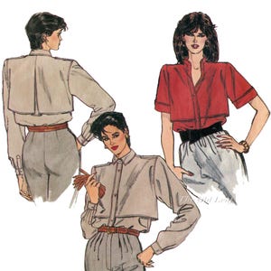 May include: Illustration of three women wearing different styles of blouses. One is red with short sleeves, another is light gray with long sleeves, and the third is light gray with long sleeves. All blouses have a similar design with a cropped, layered look. The women are wearing high-waisted pants.