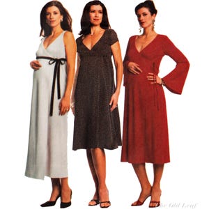 May include: Three maternity dresses in a row. The first is a light blue wrap dress with a black sash. The second is a dark brown dress with a small floral pattern. The third is a red wrap dress with long sleeves.