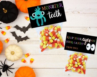 May include: Two bags of candy corn with Halloween themed gift tags. The first tag is black with a green monster and the text "Monster teeth". The second tag is black with white googly eyes and the text "Keep your eyes on your candy! From Cole."