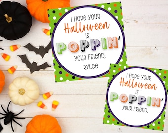 May include: Two green and white polka dot gift tags with a purple circle in the center. The text on the tags reads "I hope your Halloween is POPPIN' your friend, [name]"