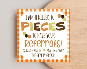 May include: Orange and white checkered card with the text "I am thrilled to pieces to have your referrals!"  Summer Smith, 555-123-4567, The Realty Group.