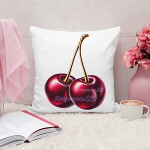 May include: White pillow with a red and gold cherry design. The cherries are depicted in a realistic style with a glossy finish. The pillow is a great addition to any home decor.