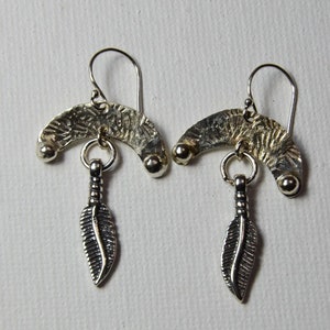 Feather danglling below half moon  textured Sterling Silver Earrings. Hook Back