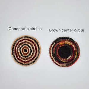 May include: Two handmade, circular rugs with concentric circles. One rug features a brown center and a mix of earth-toned colors. The other rug has a lighter color palette with a beige center and red and brown rings. Text above reads "Concentric circles" and "Brown center circle."