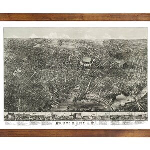 May include: A vintage black and white aerial map of Providence, Rhode Island. The map shows the city's streets, buildings, and waterways. The text "PROVIDENCE, R.I." is printed at the bottom of the map.