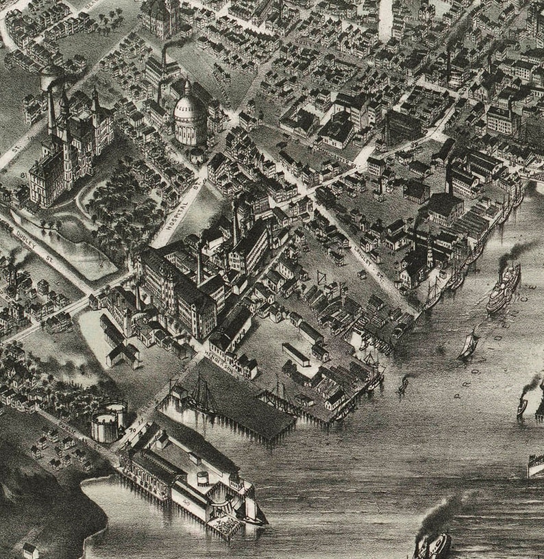 May include: A black and white aerial view of a city with a large industrial complex and a harbor. The complex is made up of many buildings and structures, including a large factory, a warehouse, and a dock. The harbor is filled with ships and boats.