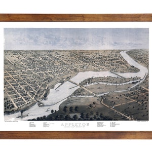 May include: An antique framed print of Appleton, Wisconsin, from an aerial perspective. The print, in shades of gray and brown, depicts the city's layout, including buildings, streets, and the Fox River. The print is encased in a dark brown wooden frame.