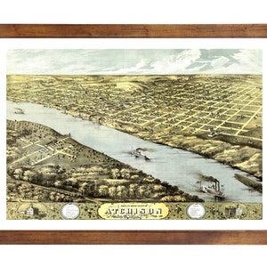 May include: Framed vintage map of Atchison, Kansas, showing a detailed aerial view of the city, the Missouri River, and steamboats. The map is in a brown wooden frame.