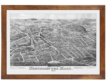 May include: A black and white vintage map of Northampton, Massachusetts from 1875. The map shows the city's streets, buildings, and parks. The map is framed in a brown wooden frame.