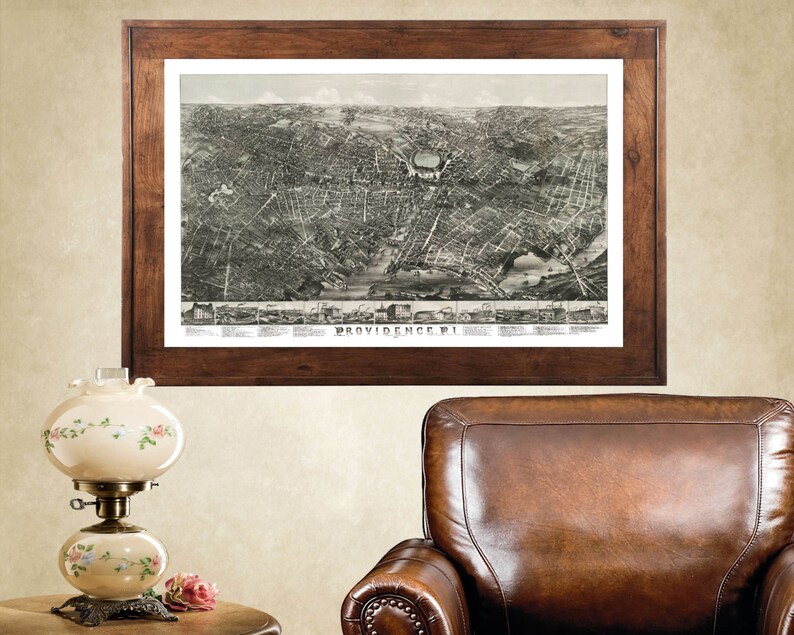 May include: A vintage map of Providence, Rhode Island, framed in a dark wood frame. The map is in black and white and shows the city's streets and buildings.