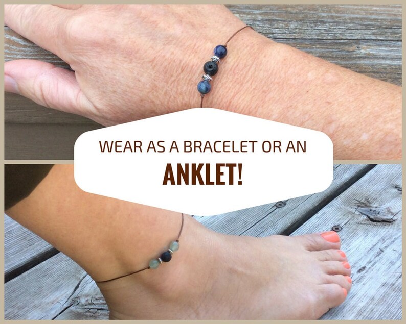 May include: A brown cord bracelet with three beads: a dark blue stone, a black lava bead, and a light blue stone. The bracelet is shown worn on a wrist and an ankle. The text "WEAR AS A BRACELET OR AN ANKLET!" is displayed on a white background.