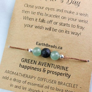 May include: Green aventurine stone bracelet with a lava stone bead and brown cord. The card reads "Green Aventurine happiness & prosperity" and "Aromatherapy Diffuser Bracelet - add a drop of essential oil to lava stone..."