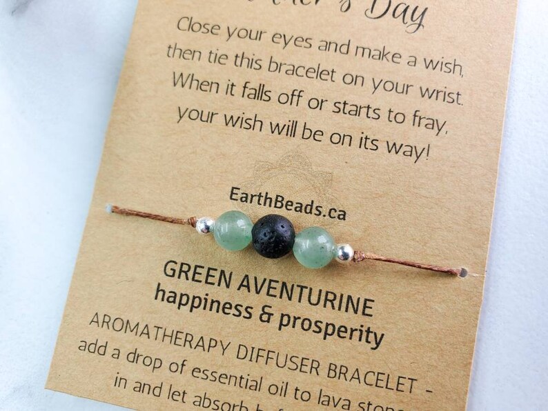 May include: Green aventurine stone bracelet with a lava stone bead and brown cord. The card reads "Green Aventurine happiness & prosperity" and "Aromatherapy Diffuser Bracelet - add a drop of essential oil to lava stone..."