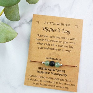 May include: A brown card with the text "A Little Wish For Mother's Day" and instructions for making a wish with a green aventurine and lava stone bracelet. The card also says "Green Aventurine happiness & prosperity" and "Aromatherapy Diffuser Bracelet - add a drop of essential oil to lava stone, rub in and let absorb before wearing."