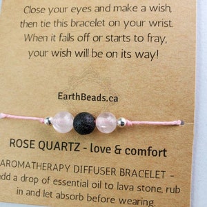 May include: Pink string bracelet with a rose quartz bead, a black lava bead, and silver spacer beads. The card reads "Close your eyes and make a wish, then tie this bracelet on your wrist. When it falls off or starts to fray, your wish will be on its way! EarthBeads.ca ROSE QUARTZ - love & comfort AROMATHERAPY DIFFUSER BRACELET - add a drop of essential oil to lava stone, rub in and let absorb before wearing."