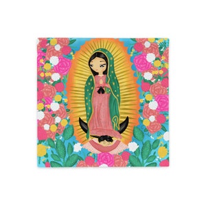 May include: A colourful illustration of the Virgin Mary, depicted as a young woman with a crown of flowers, standing on a crescent moon. She is wearing a blue and green robe and holding her hands in prayer. The background is filled with flowers and cacti.