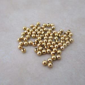 small 2.4mm gold plated steel round beads