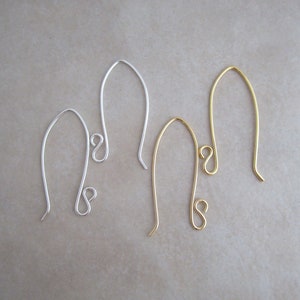 May include: Two pairs of earring hooks, one pair is silver and the other is gold.