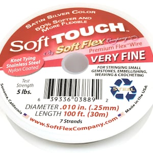 May include: A spool of satin silver Soft Flex Company Premium Flex wire, very fine, for stringing small gemstones, embellishing, weaving and crocheting. It is 50% softer and more flexible than other wires. The spool is 100 feet long and has a diameter of 0.010 inches. It is made in the USA and has a test strength of 5 lbs.
