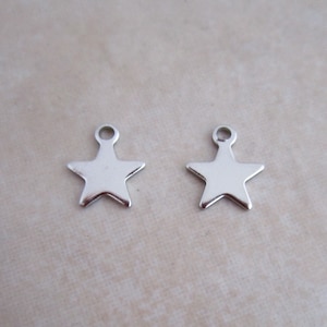 May include: Two silver star-shaped charms with a jump ring at the top.