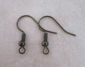 May include: Two antique gold-toned earring hooks with a spring clasp and a small ball at the top.