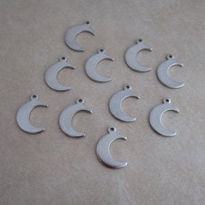 May include: Ten silver crescent moon charms with a hole at the top for attaching to jewelry or other crafts.