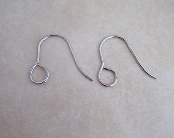 May include: Two silver earring hooks, each with a small loop at the top and a curved wire extending down.