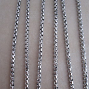 May include: Five strands of silver chain, each with a box chain pattern.