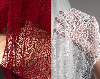 May include: Close-up of two sections of open weave fabric. One section is a deep red, the other is white. The fabric has a delicate, web-like pattern, with small, irregular openings throughout. The texture appears soft and airy.