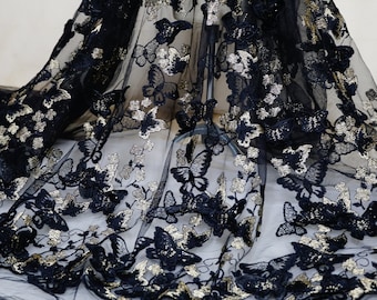 May include: Black sheer fabric with gold glitter butterflies embroidered on it.