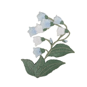 May include: A delicate embroidered patch featuring a cluster of light blue and white bell-shaped flowers with green leaves. The flowers are arranged in a cascading pattern, creating a whimsical and elegant design.
